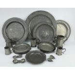 Collection of antique pewter chargers, mugs, moulds and serving dishes