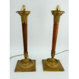 An impressive pair of Empire revival style gilt brass and mahogany lamps