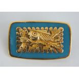 A Peruvian 18ct Gold brooch featuring an Incan Chaskis mounted on blue glass