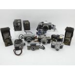 Eleven vintage cameras including Kodak, Praktica, Werra, Olympus and Comet.