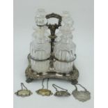 A Victorian silver plated 4 decanter liqueur set with bottle tickets.