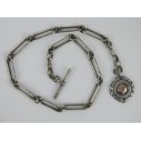 A heavy long link silver watch albert chain and fob.