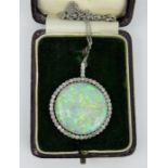 Large Art Deco Australian cabochon white opal pendant with diamond set border.