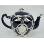 An Art Nouveau style white metal cased ceramic tea pot