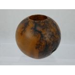 A 'Lightning Art' turned burr walnut orb votive candle holder.