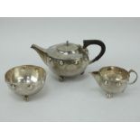 Three piece planished silver Arts & Crafts tea set by A E Jones, 1911