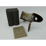 An Underwood & Underwood stereoscope and two volumes of world stereocards in box