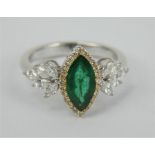 A pretty 18ct white gold marquis cut Colombian emerald and diamond ring