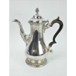 George III silver coffee pot with gadrooned decoration and acanthus leaf spout. 1762