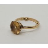 A 9ct. gold yellow topaz cocktail ring, set mixed round cut yellow topaz to centre, fitted with ring