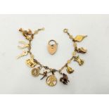A 9ct. gold fancy link charm bracelet suspending several 9ct. gold charms, together with 9ct. gold