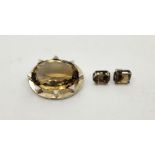 A white metal and citrine brooch, set large mixed oval cut citrine, length 44mm, together with a