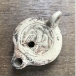 Roman East African oil lamp decorated with bird and figure, small size.