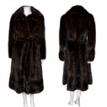 A dark chocolate mink coat C1970s, high quality part waisted design with tie belt. Fur hook