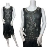 A 1920s beaded flapper dress, made in France. Made from cotton muslin with a handkerchief hem that