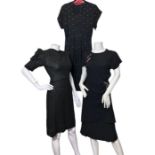 A 1940s crepe dress with sarong style wrap effect skirt and beaded cherry motifs on the bodice and