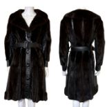 A 1970s leather and dark chocolate mink panel coat with button fastenings, belt waist and large