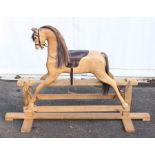 Rocking Horse: A mid-late 20th century wooden rocking horse, with padded saddle, very good