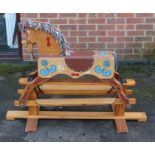 Rocking Horse: A modern, small child's rocking horse with painted design and colourful mane.