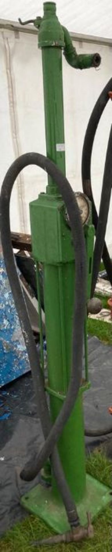 Vintage green hand cranked petrol pump.