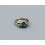 A treated zircon and natural diamond 18ct yellow gold dress ring, size I. Approximate weight 3.6gm