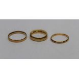 Three 22ct gold band rings, total approximate weight 6.9 grams. (3)