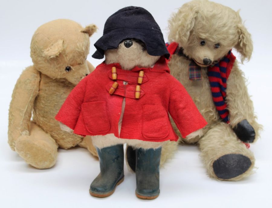 An early 1970's Paddington Bear, wearing red duffle coat, blue felt hat and wellington boots,