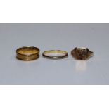 A selection of three yellow metal rings, one yellow metal and stamped 18c, 2.1gm, a 9ct hallmarked