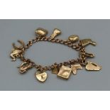 A 9ct gold charm bracelet featuring thirteen charms and heart padlock. Gross weight approximately