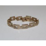 A 9ct gold and cubic zirconia set brick bracelet. Gross weight approximately 15.6 grams.