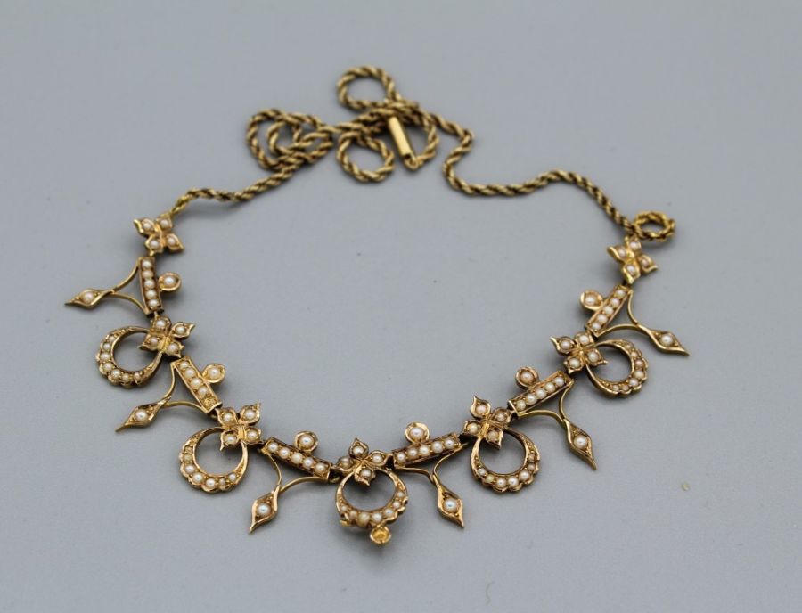 A seed pearl set, late 19th century/ early 20th century, yellow metal foliate necklace, with a