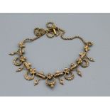 A seed pearl set, late 19th century/ early 20th century, yellow metal foliate necklace, with a