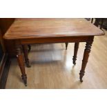 A George IV mahogany pull-out dining table on turned legs and castors - one leaf.