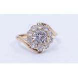 A white sapphire gold cluster ring, comprising a central round mixed cut stone within a border of