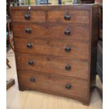 A George III tall oak chest of two over four drawers with wooden knob handles.