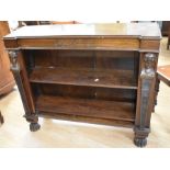 A Victorian mahogany bookcase with carved head side detail, on lions' feet, together with an early