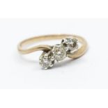 A three stone diamond and 9ct gold ring, comprising three round brilliant cut diamonds illusion set,