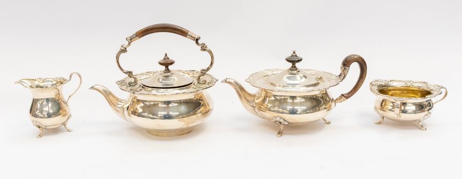 A George V silver four piece tea set comprising teapot, kettle, milk jug and sugar bowl, circular