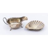A late Victorian silver shell shaped butter dish on three ball feet, hallmarked by Goldsmiths &