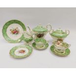 An early 20th Century apple green tea service, decorated with a floral design