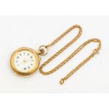 A ladies early 20th century 9ct gold open faced pocket watch, comprising a white enamel dial,