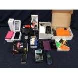 A collection of boxed mobile phones including iphones, LG, Sony and others