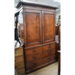 A 19th Century mahogany linen cupboard having two cupboard doors opening to reveal linen trays,