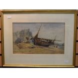 A late 19th century watercolour of a fishing boat on a beach, signed bottom right - 39cm x 23cm.