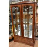 A late 20th Century mahogany effect glazed display cabinet with three glass internal shelves