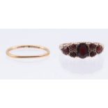A garnet and 9ct gold ring, scrolled mount, size N1/2, total gross weight approx 3.5gms, along