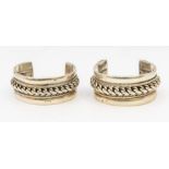 Two silver torque cuffs, both similar comprising wide form with a wide roped centre within a