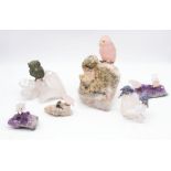 A collection of six Brazilian carved crystal birds, to include amethyst and quartz, tourmaline in