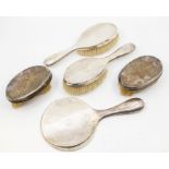 A collection of silver dressing brushes and mirror to include; A matching pair of brushes, both