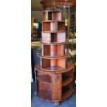 A reproduction, mahogany, graduated, circular, revolving bookcase with seven bookshelves and lion'